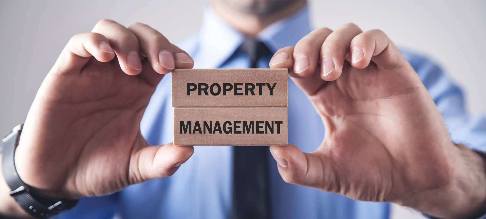 Man holding wooden blocks. Property Management